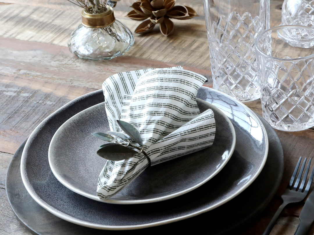 Chic Antique Papierserviette mit Streifen in Olive dekorativ gefaltet auf Teller bei Tischdekoration im skandinavischen Landhausstil