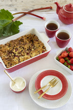 GreenGate Alice Auflaufform Rot mit Rhabarber-Crumble auf gedecktem Tisch im skandinavischen Landhausstil